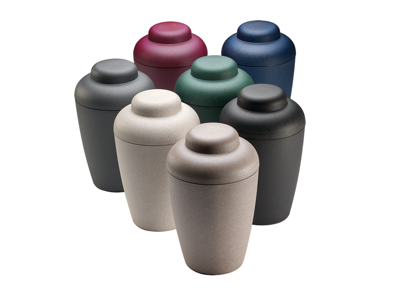 The seven NatureUrn colours: nature, white, charcoal, black, green, red and blue biodegradable cremation urns
